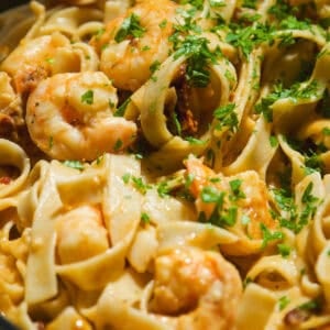 Marry me pasta with shrimp and parsley on top.
