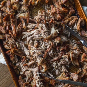 A baking sheet filled with shredded pulled pork.