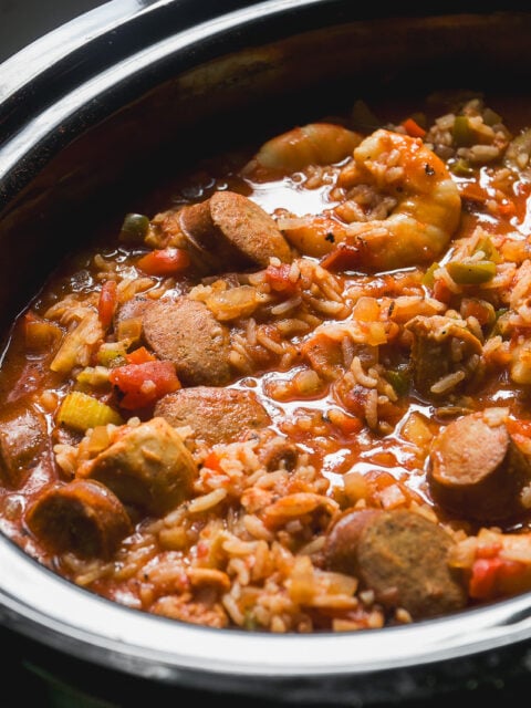 Jambalaya with shrimp, sliced sausage, and rice in a slow cooker.
